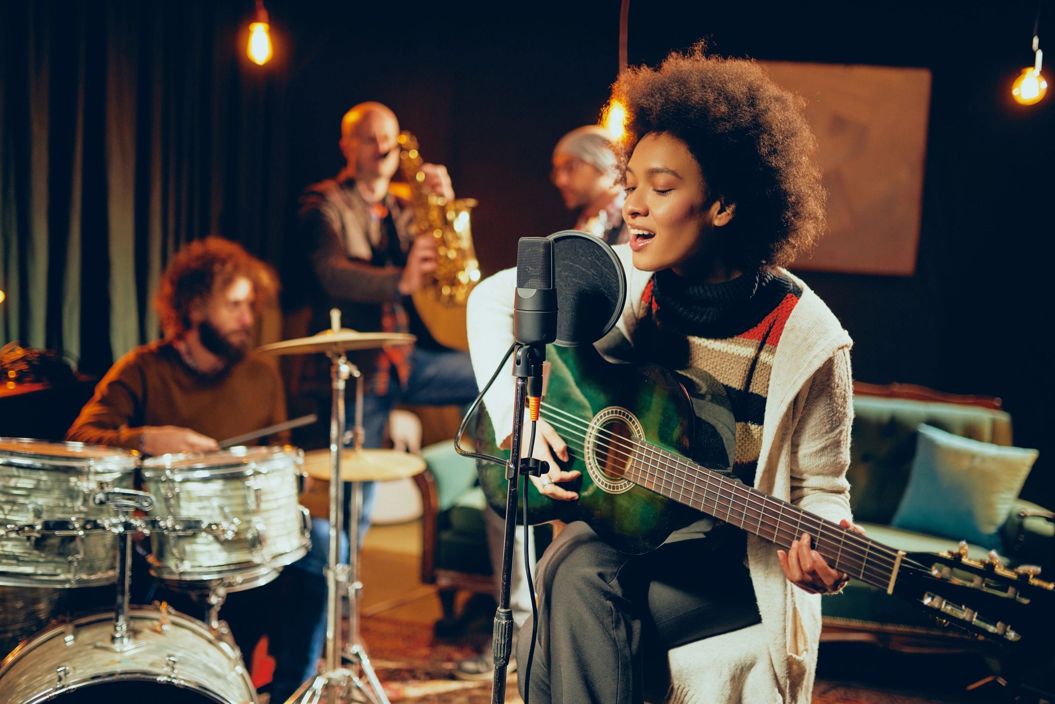 Band performing with singer and instruments.