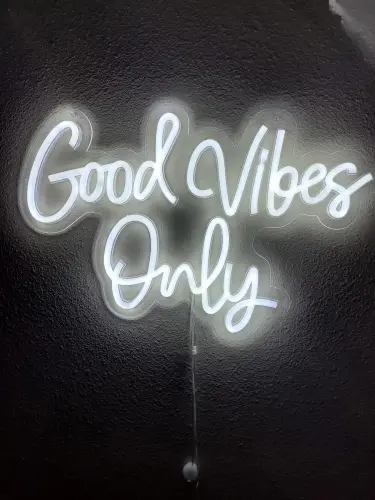 Neon sign glowing with the phrase 'Good Vibes Only'.